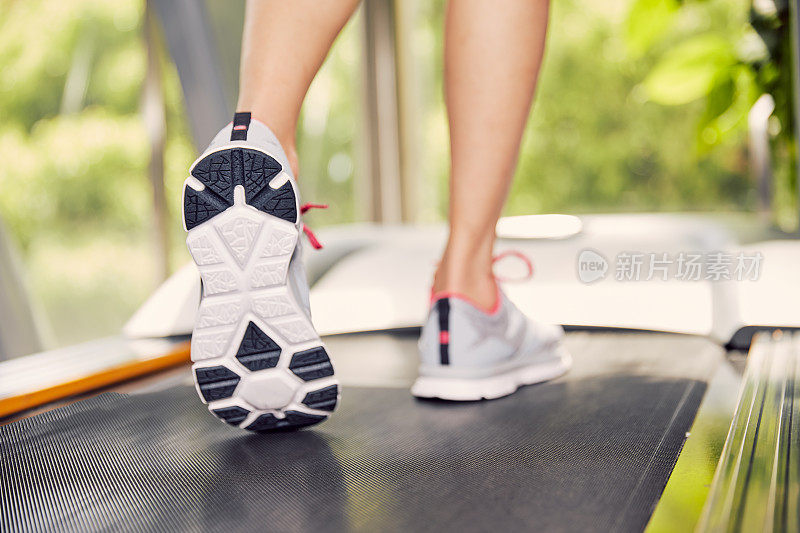 Fitness girl running on treadmill